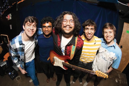 Chance Emerson and his bandmates smile backstage before a show 